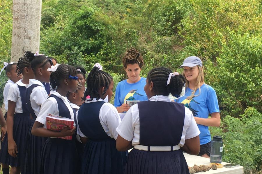 Ariane rojin teaching a classroom of students outside.