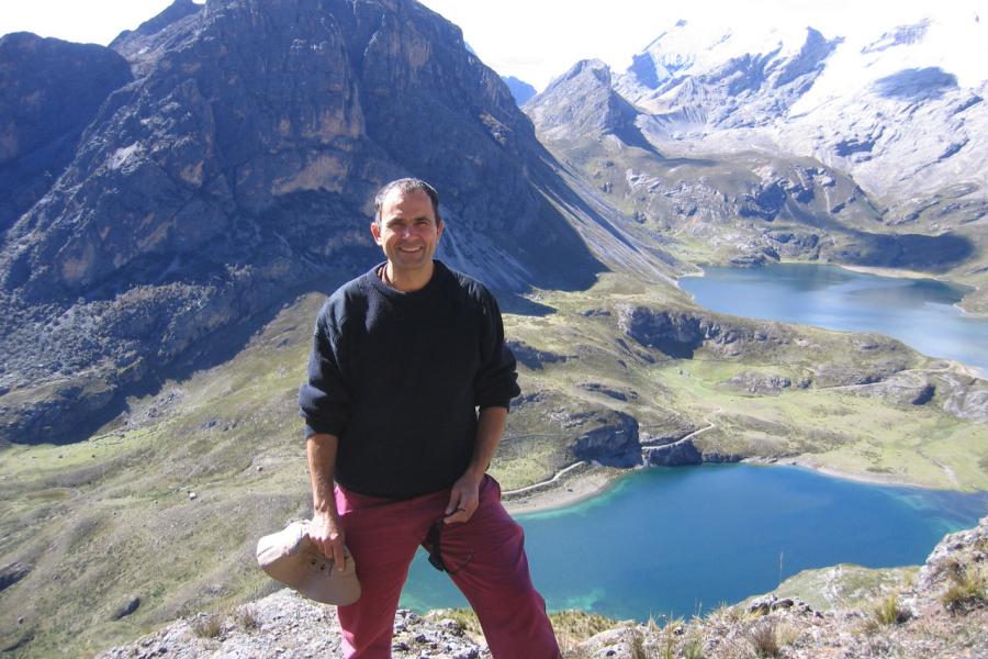 Doctor alfredo camacho standing in front of some mountains.