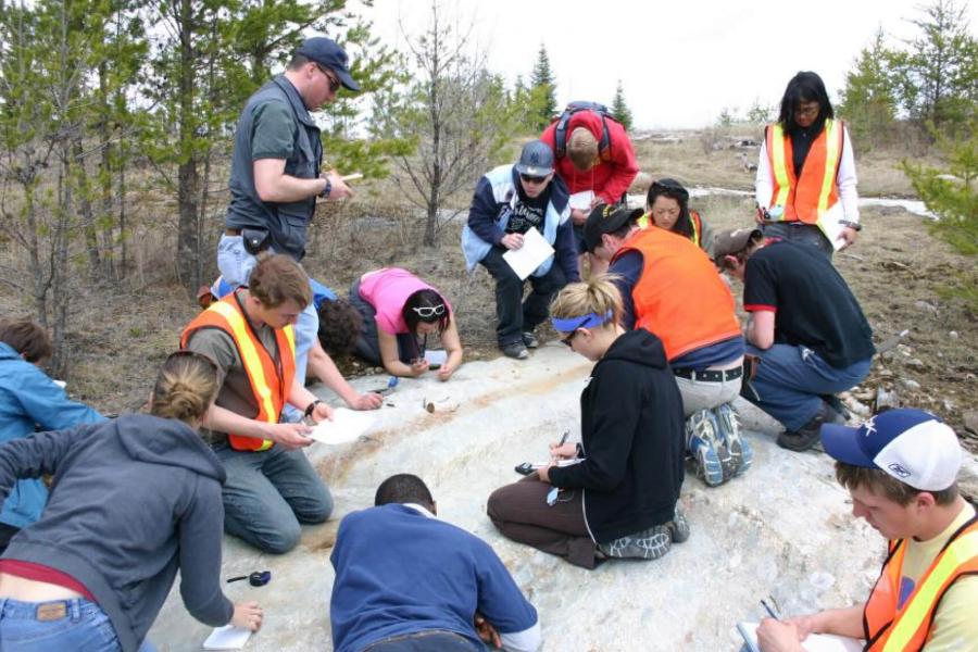 Geology students working together at an outdoor site.