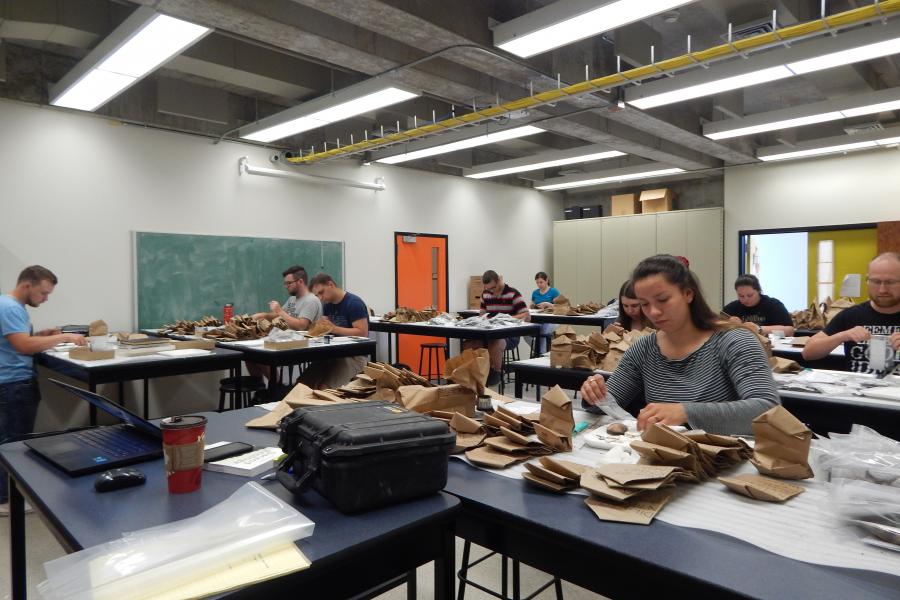 Students working in Anthropology lab. Examining artifacts.
