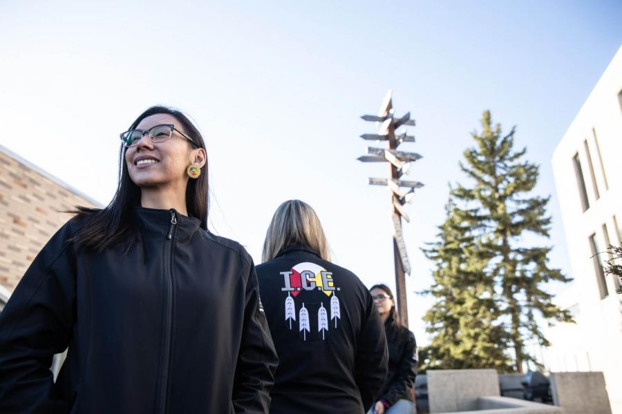 Three Indigenous students stand together, each of them wearing Indigenous Circle of Empowerment jackets.