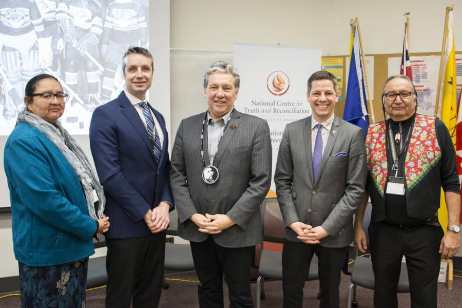 Dr. Moneca Sinclaire, MLA Andrew Smith, MP Dan Vandal, mayor Brian Bowman and Cultural Teacher and Leader Carl Stone stand together at the Sport and Reconciliation Gathering.