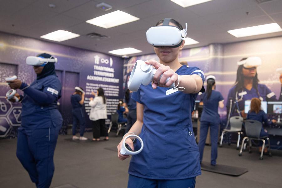 A nursing student using virtual reality equipment.