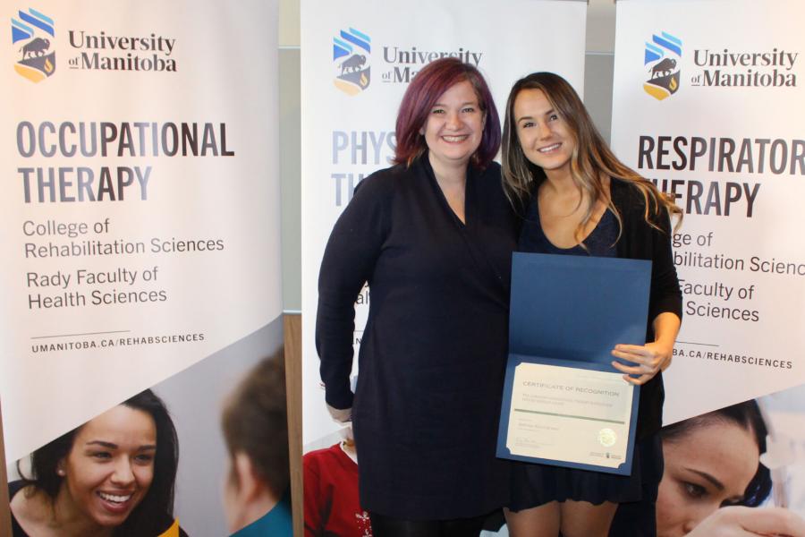 Occupational therapy student Andreea Alexandrescu stands holding her Future Scholar award.