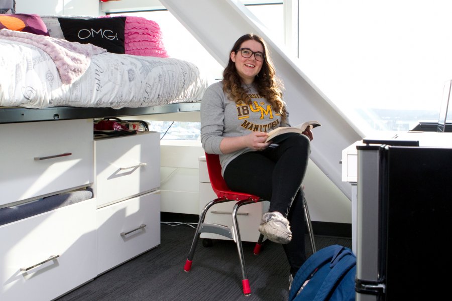 A University of Manitoba student sits in her Pembina Hall Residence room studying.