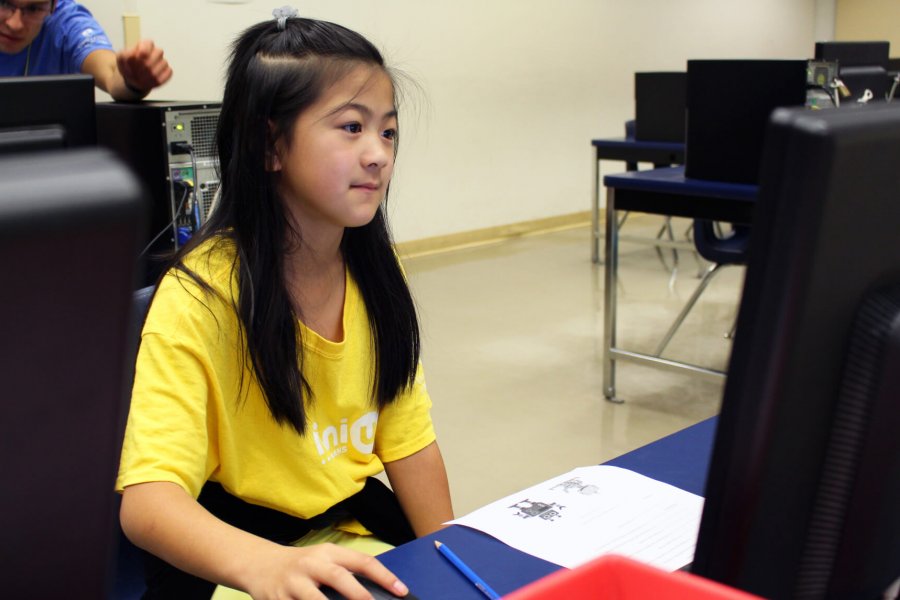 A Mini U junior coding in a computer lab.