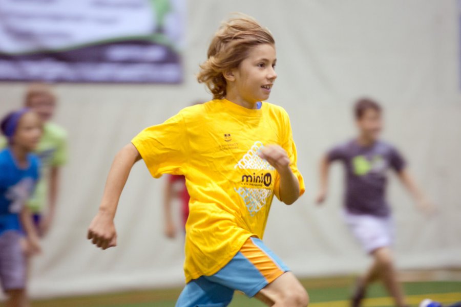 Children running in a gymnasium.