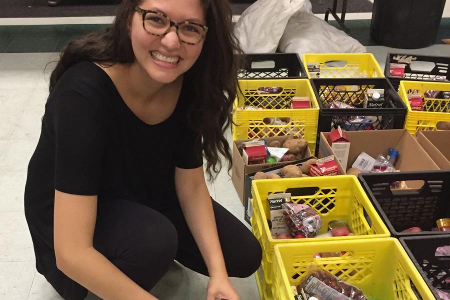 Student putting food into cartons.