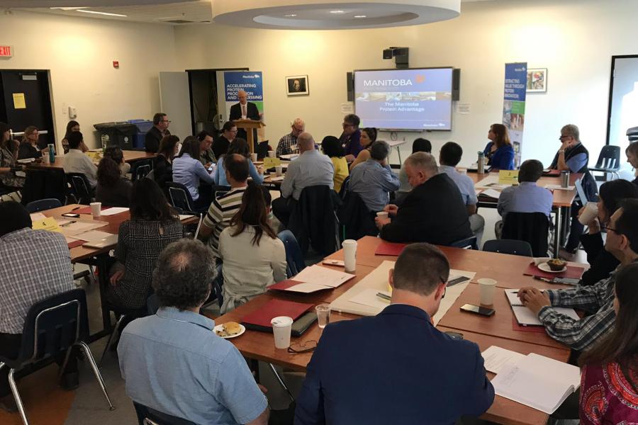 Faculty and industry members gather in a meeting room.