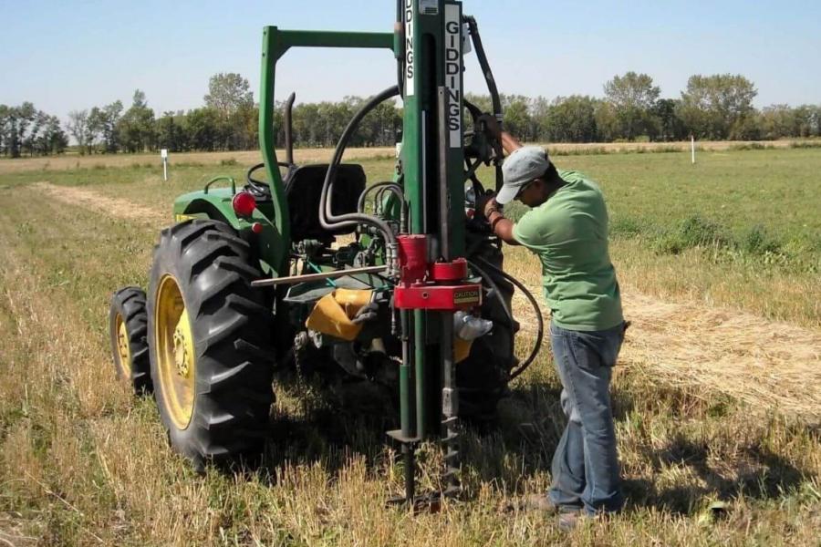 Man working with flight auger.