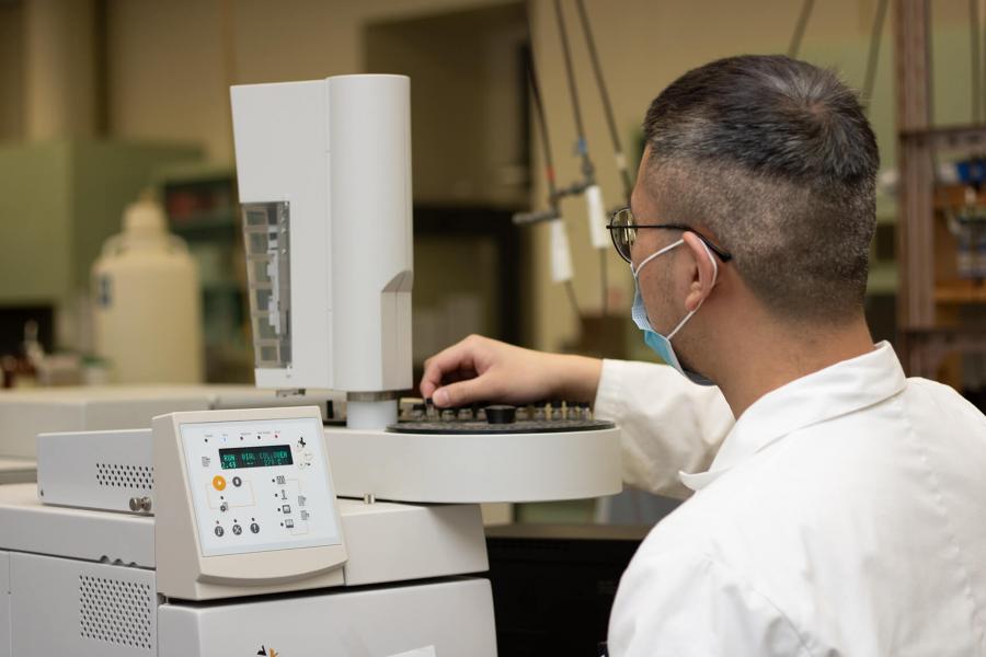 Student operating lab equipment.