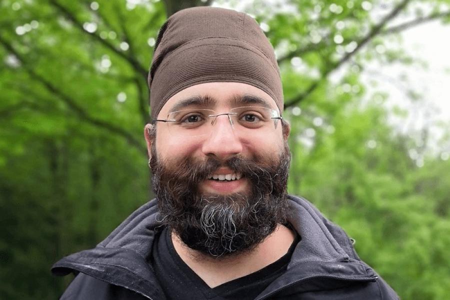 Harmeet Chawla standing in front of trees.