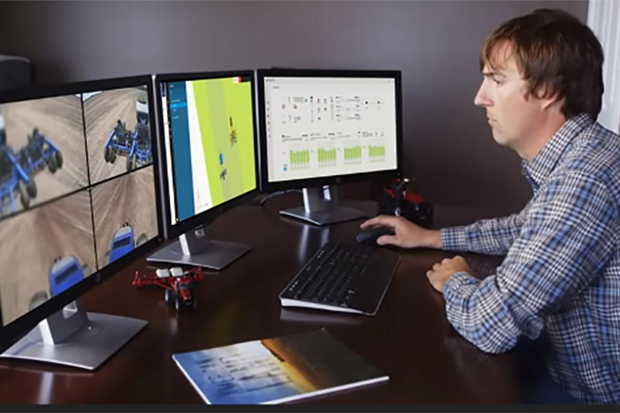 A male technician monitors autonomous equipment at work