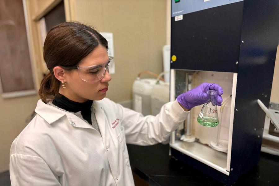 technician looking at the lab beaker