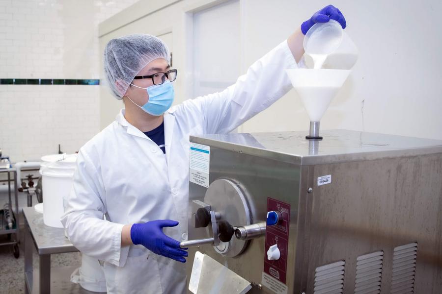 A tech feeds liquid into equipment