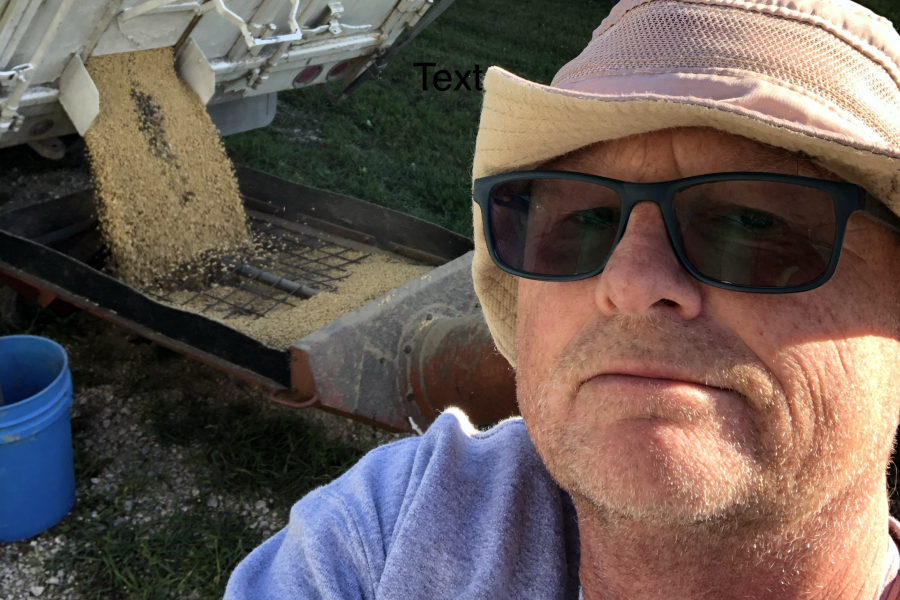 A picture of Rob Visser in front of a grain truck