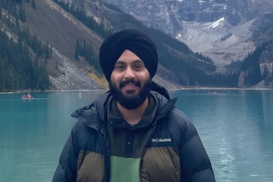 A headshot of a person in front of a lake and mountains in Banff, Alberta