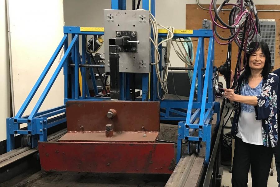 Dr Ying Chen works in the lab with agricultural equipment