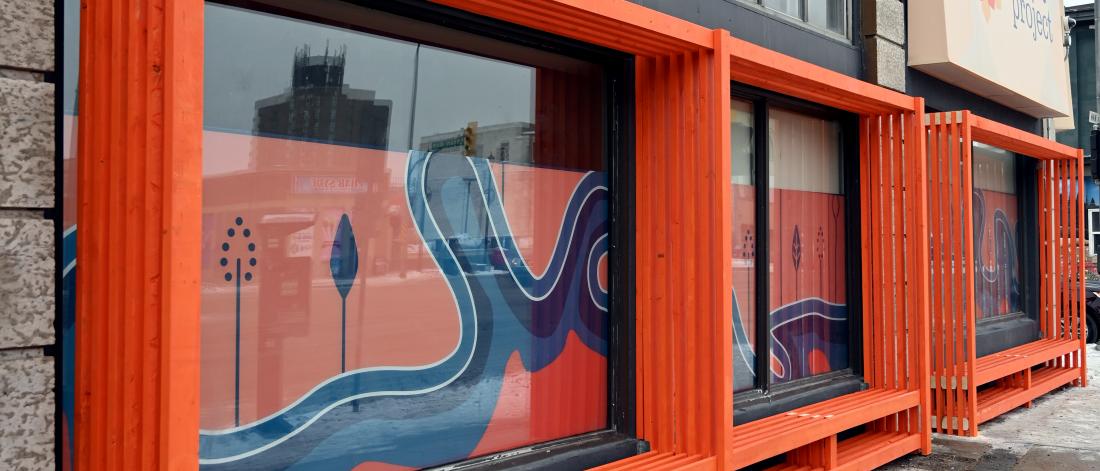 orange benches against a building outside