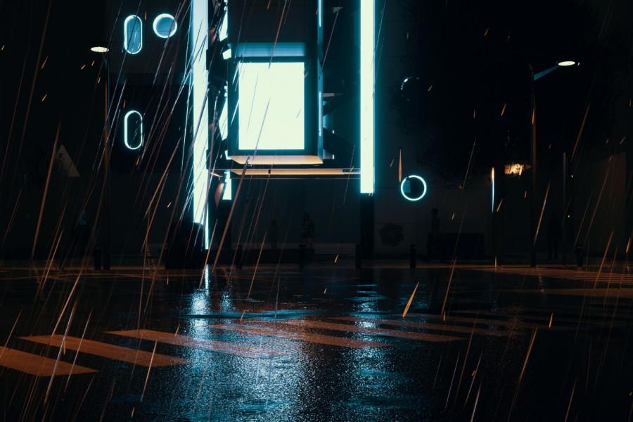 A computer kiosk glows in a dark street suggesting creativity needs a space to flourish in a digital world.