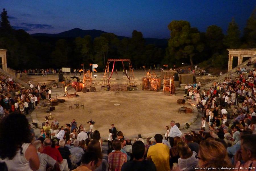 Crowd sitting around a performance circle