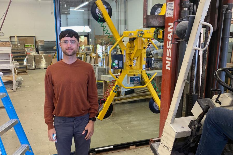 a student standing in a warehouse