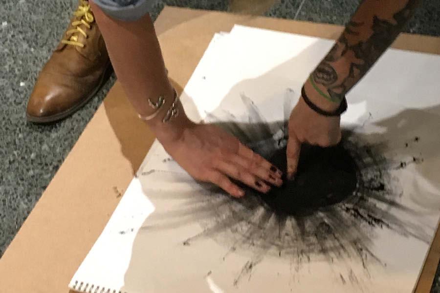 student drawing with black conte