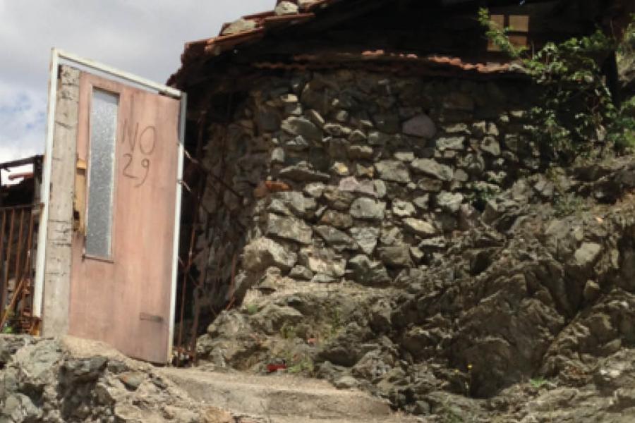 a pink door in the side of a mountain