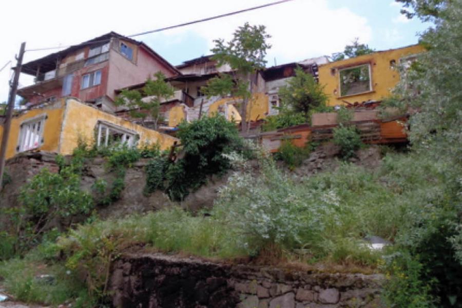 red and yellow house on the side of a mountain