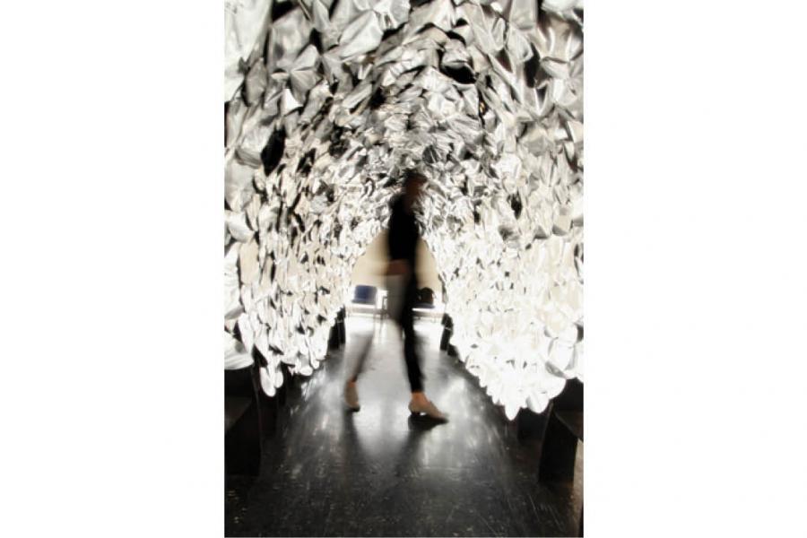 person walking in a dome of reflective materials