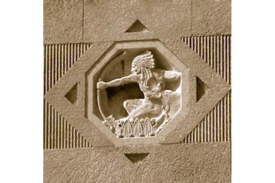 carving of man with an arrow 