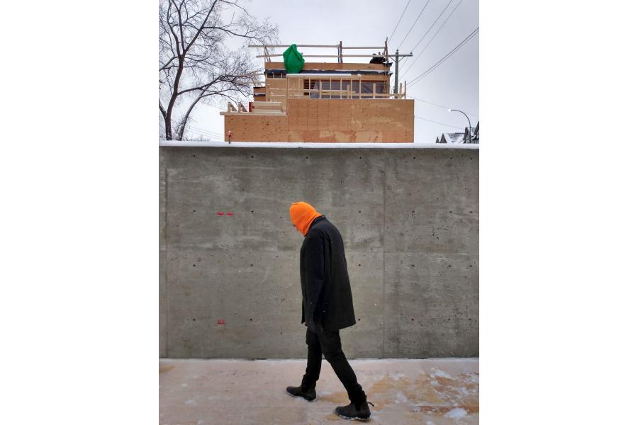 Neil walking in front of construction.