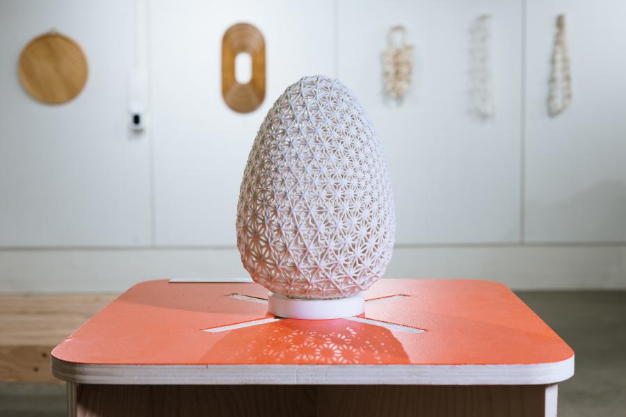 3D printed egg on orange table