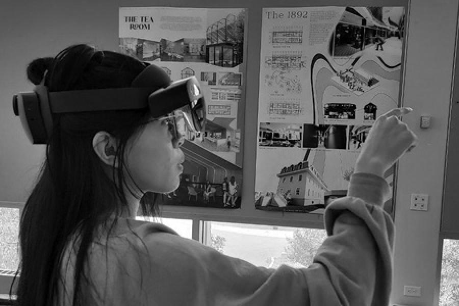 girl with virtual reality googles on pointing at the wall