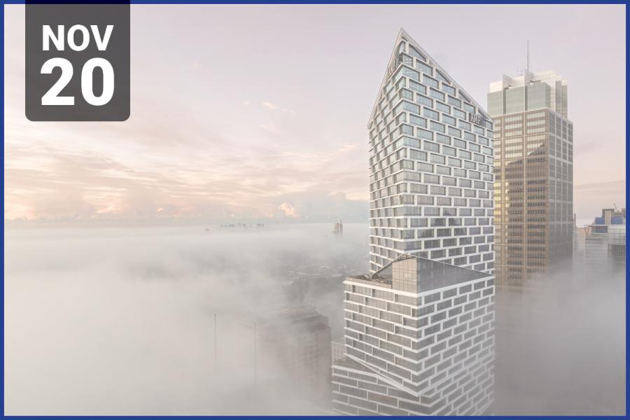 Photo of modern office tower building, above clouds and city skyline