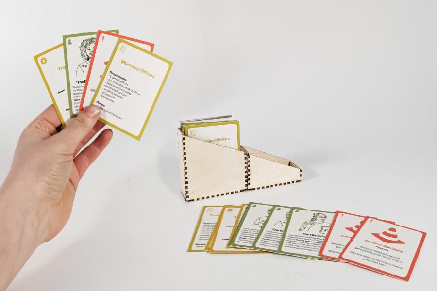 hand holding up playing cards of building instructions