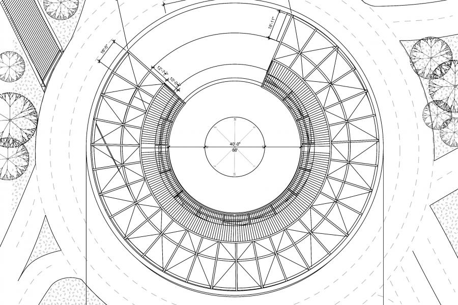 A circular structure with trees and roads