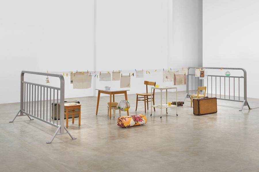 A white room with furniture and luggage