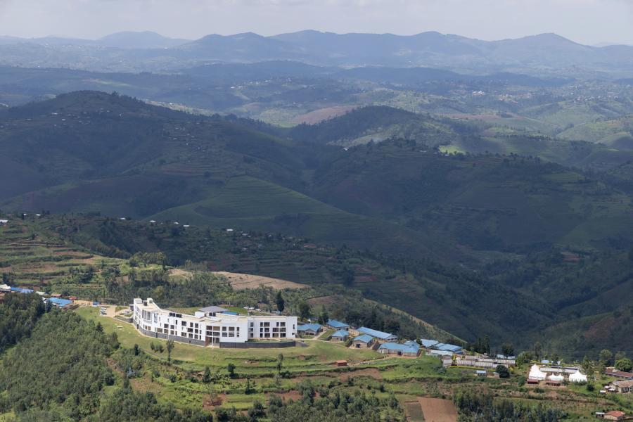 Hills and valleys with a linear white apartment complex.