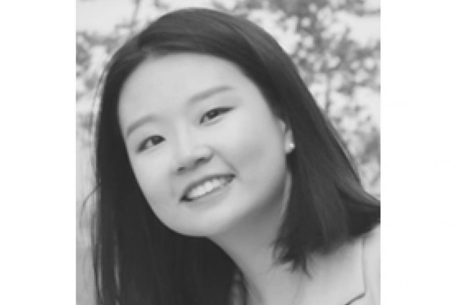 Black and white close-up photo of a person smiling.