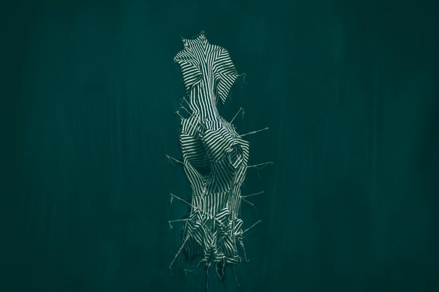 Abstract striped sculpture resembling a distorted torso against a dark green background.