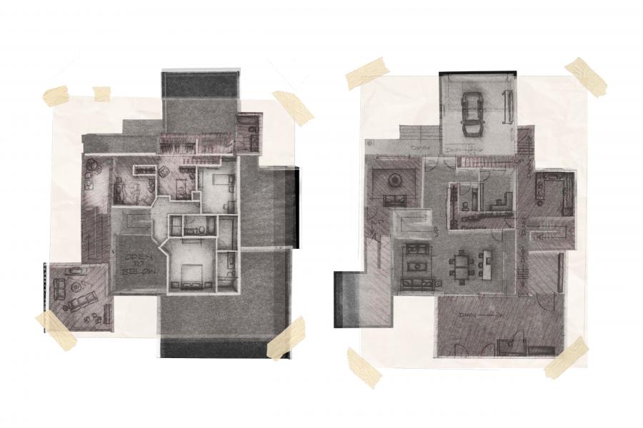 Floor plans of two-story house sketched on paper, taped corners visible. Left shows upper level; right displays lower level with garage and living spaces.