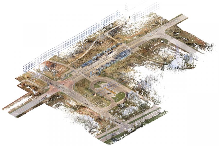 Aerial view of a detailed 3D render of a road intersection with tram tracks, sidewalks, and greenery. Power lines and paths are visible, set against a white background.
