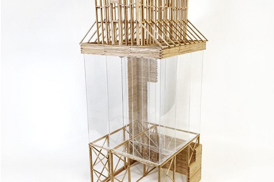 Architectural model of a house with a sloped roof, made of thin wooden beams and clear panels, showcasing an open, airy structure.