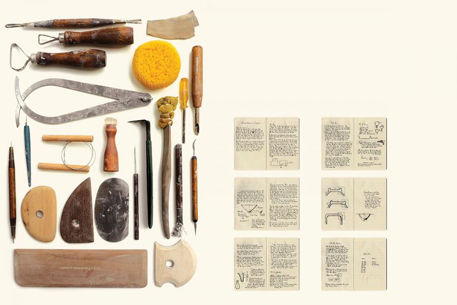 Assorted pottery tools and a sponge are neatly arranged on the left, while open notebooks with sketches and handwritten notes are lined up on the right.