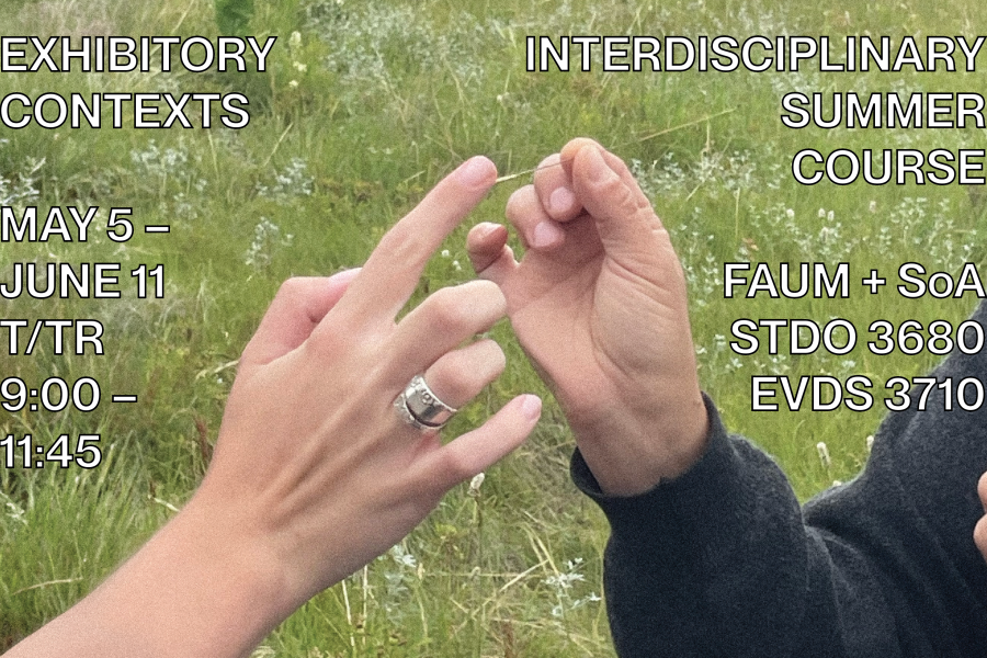 Two hands almost touching in a grassy field.