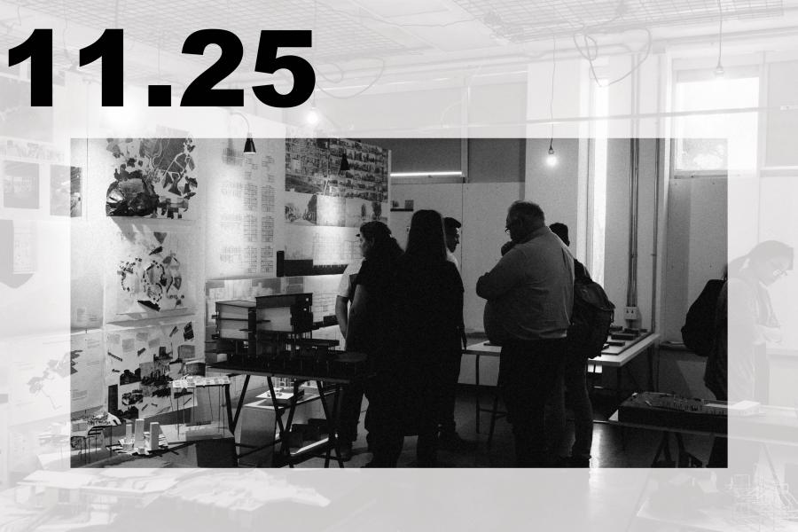 Black-and-white gallery scene with visitors viewing artworks and display tables.