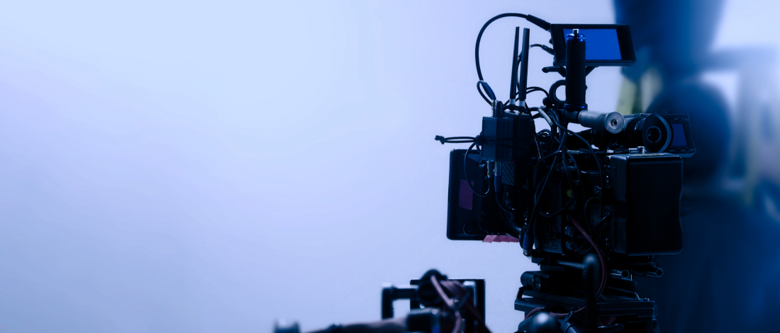 Silhouette of a video camera on a light blue background