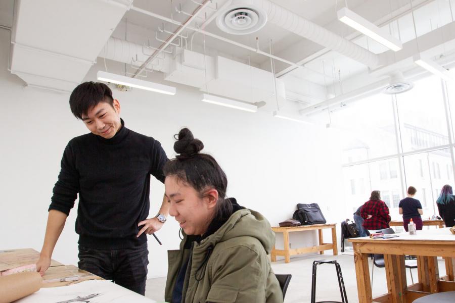 A student looks at another's work inside one of the spacious drawing studios.