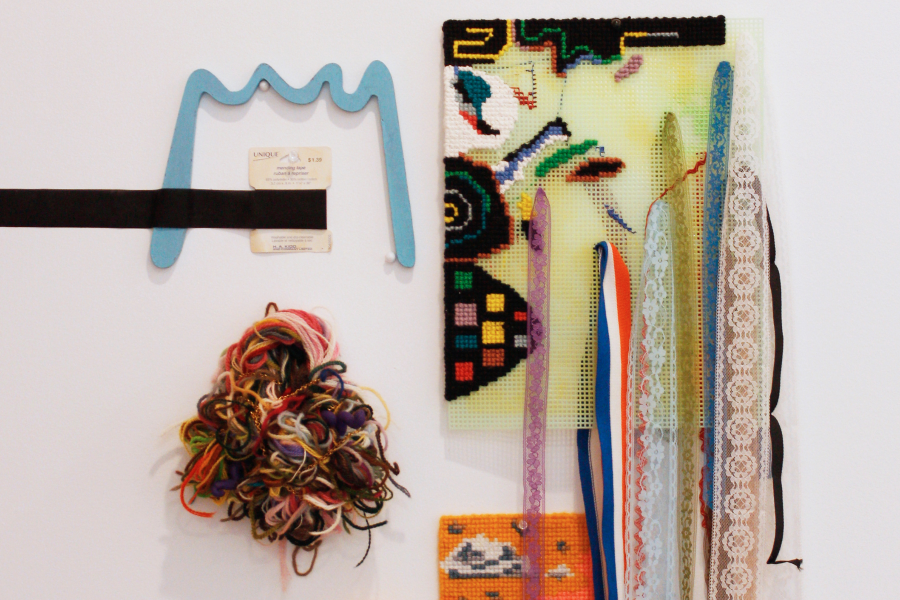 Lauren Prousky, The inherent cost of line that hugs, 2020, yarn, plastic canvas, chains, finger puppet, hemming, acrylic, wood, and mending tape. Originally exhibited at the Museum of Jewish Montreal, 2021. Photo: Karice Mitchell.